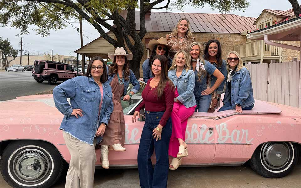 Bachelorette Party 22 Bachelorette party wine tour in Fredericksburg TX with friends raising glasses and celebrating at a scenic Texas Hill Country vineyard